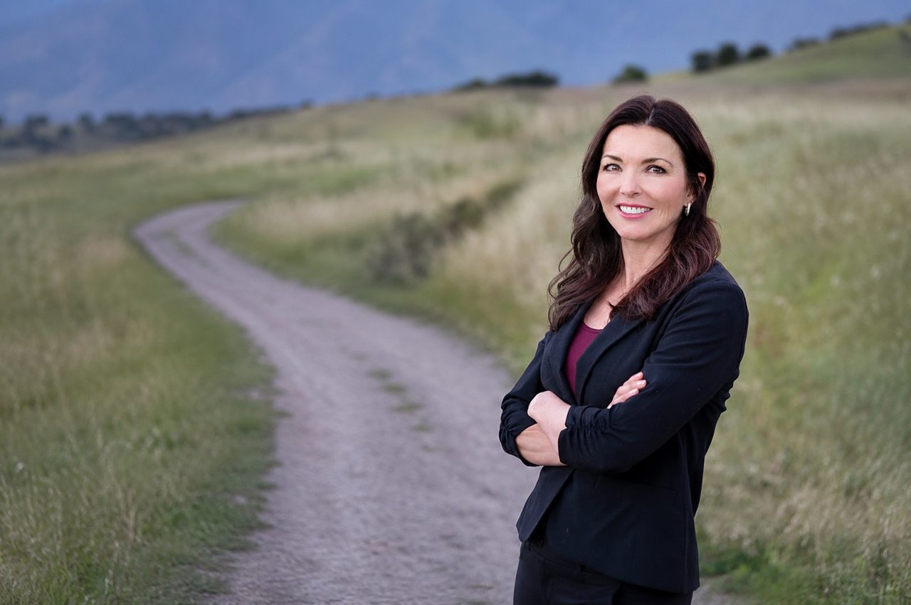 Janie Hart, LMFT, standing on a path through a sunlit field