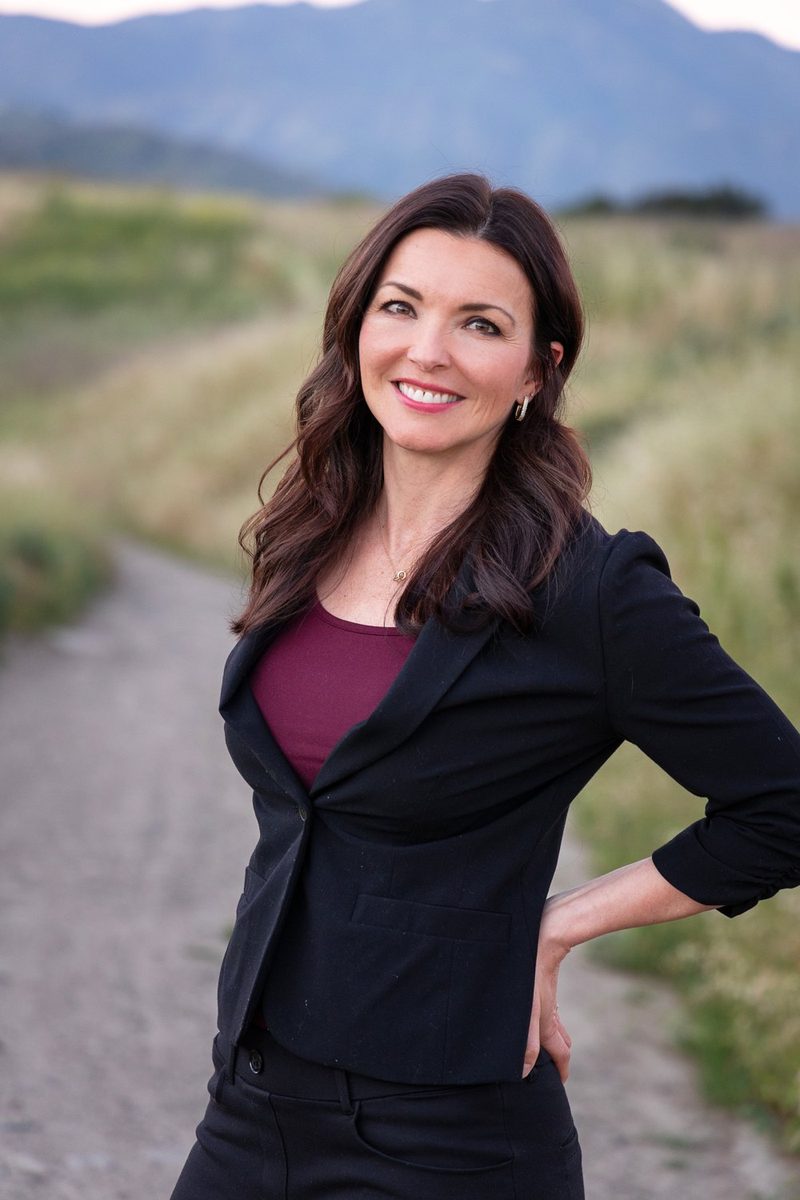 Janie Hart, LMFT, outdoors near a field path